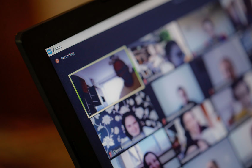Screen shot of tablet showing a video conference with multiple participants.